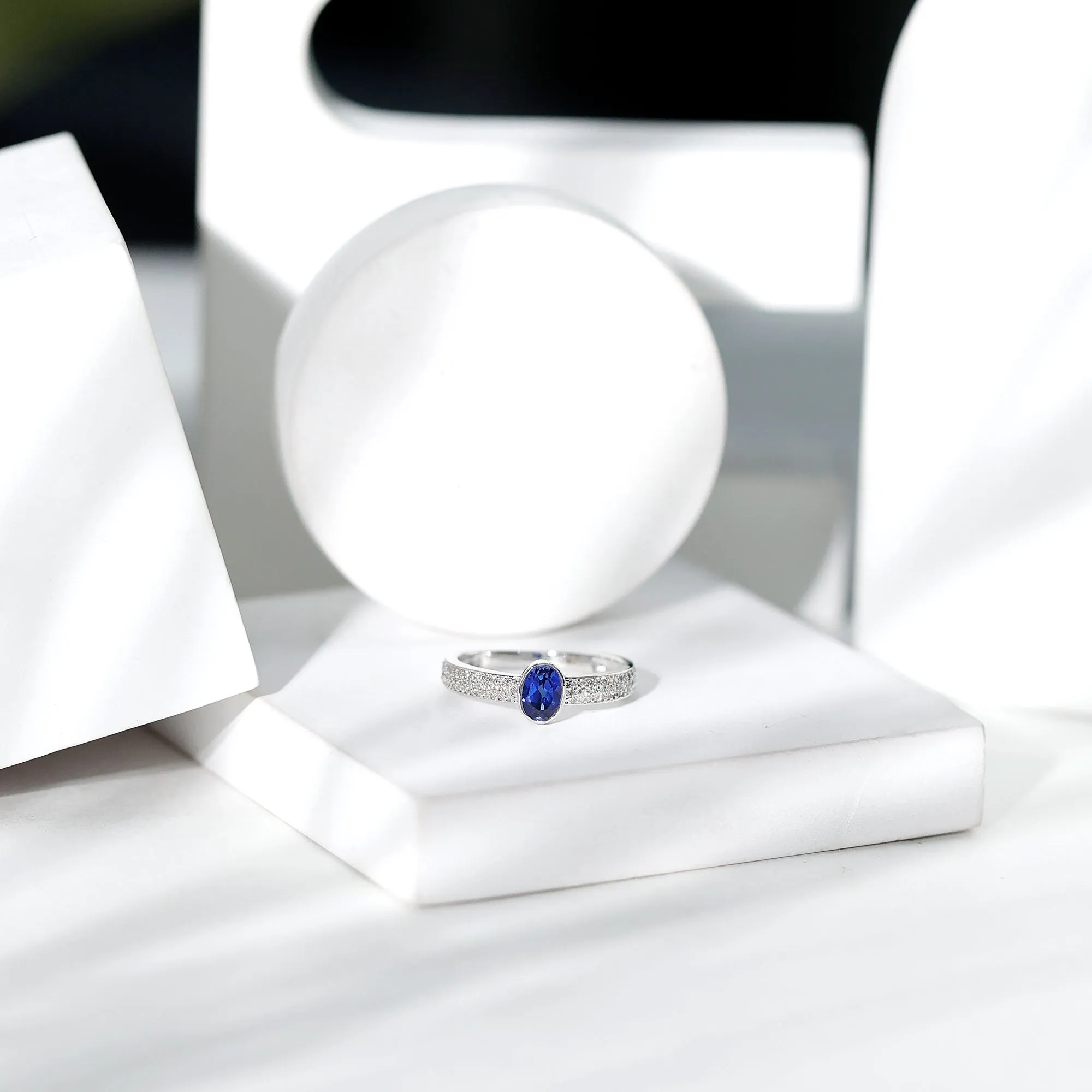 Oval Created Blue Sapphire Solitaire Engagement Ring with Diamond Side Stones